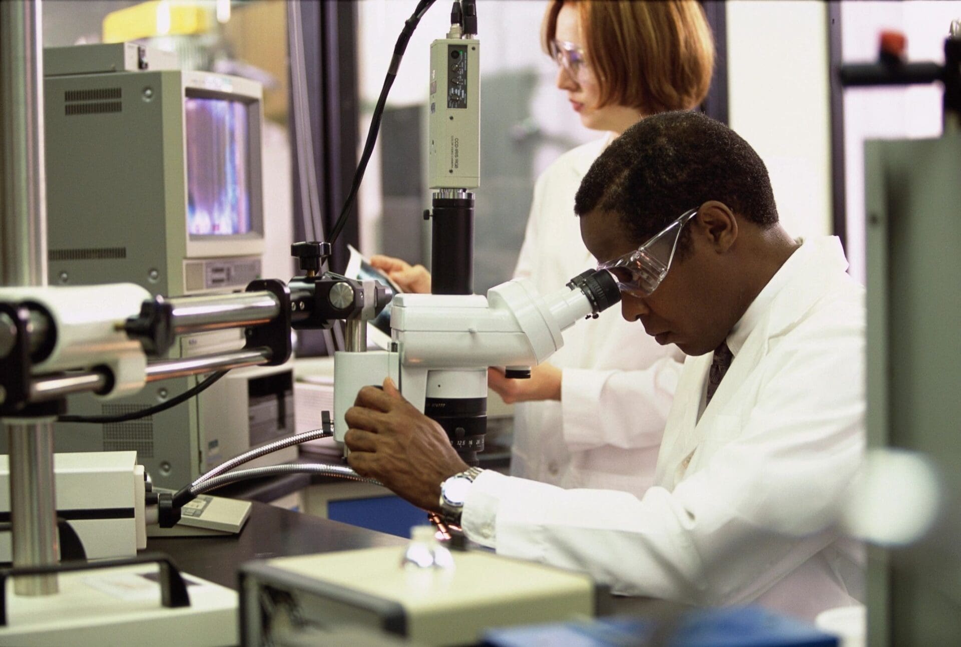 A man working in a lab with a woman.