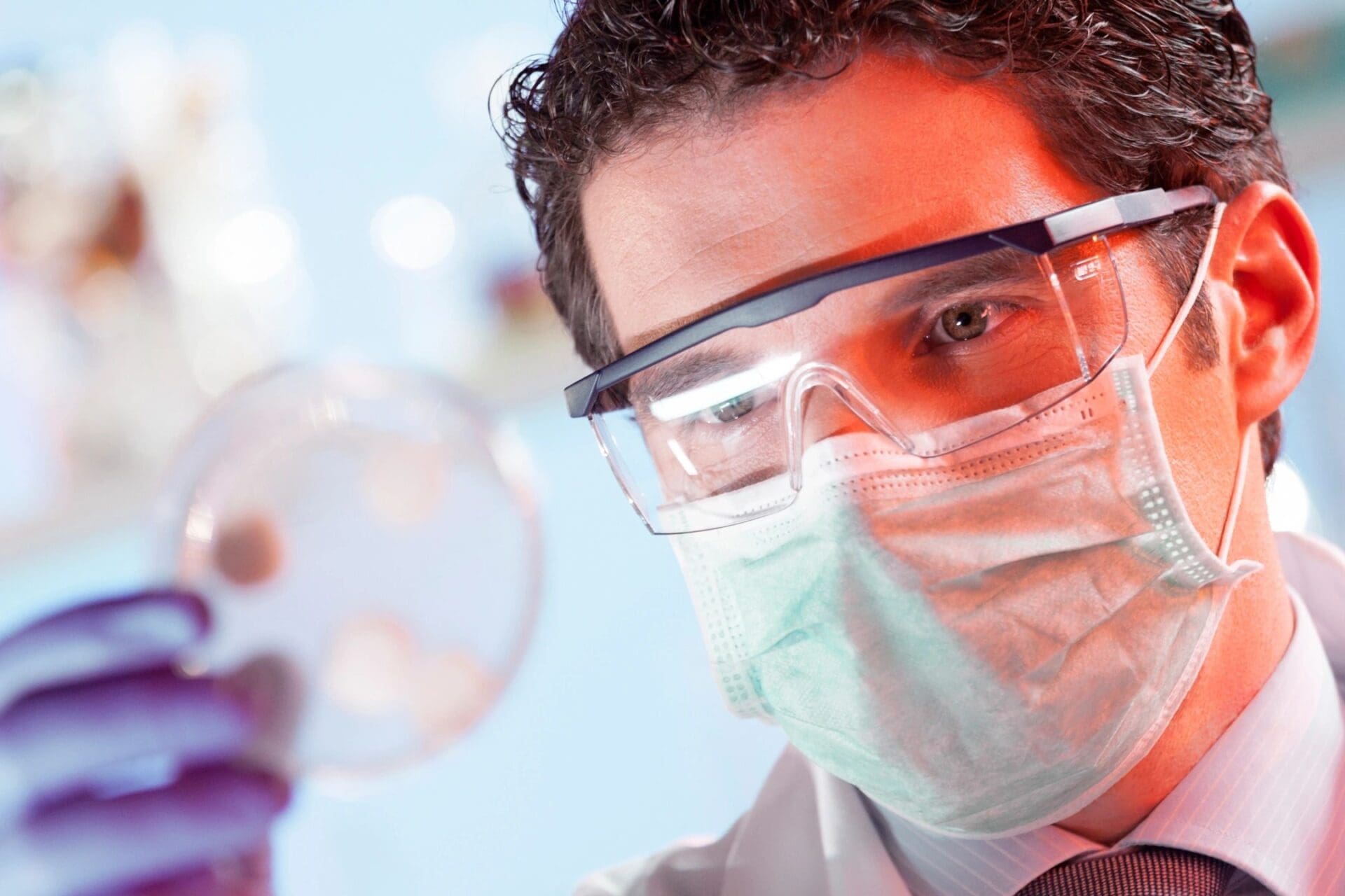 A man wearing safety glasses and a mask.