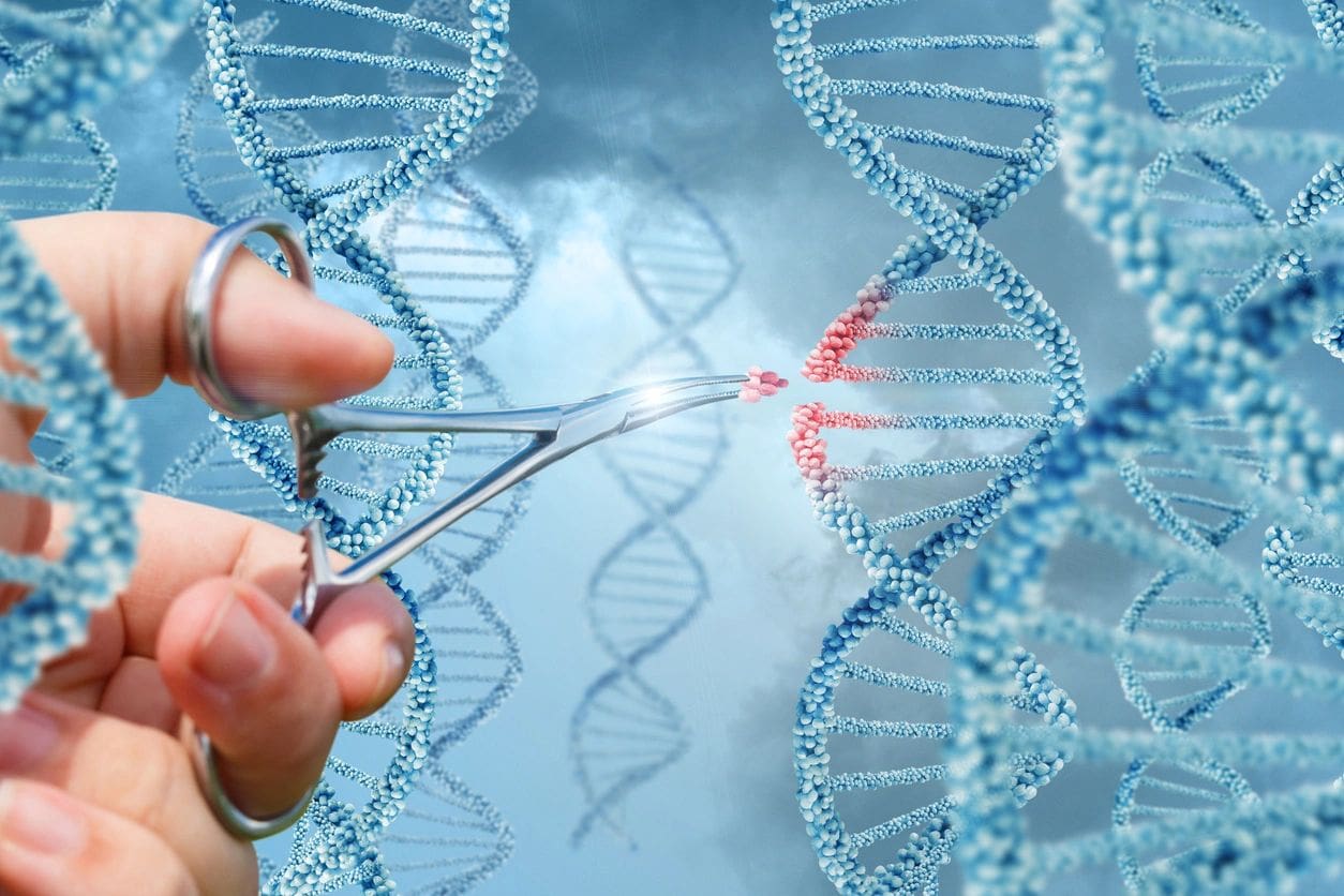 A person holding scissors cutting through dna.